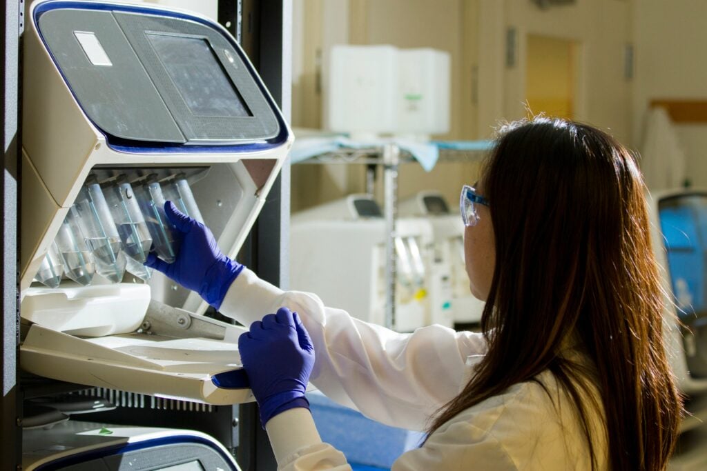 what is life science recruitment: it is a chemist handling test tubes in a lab