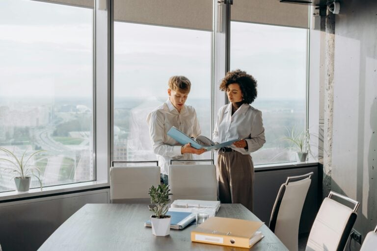 two accounting recruiters looking over candidates resumes