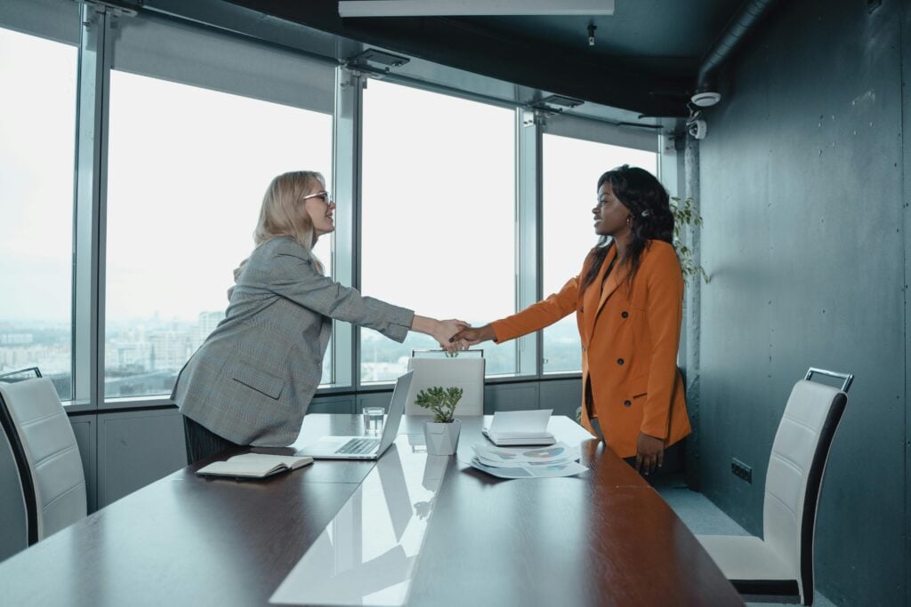 law firm exec shaking hands of new hire after using an attorney recruiter